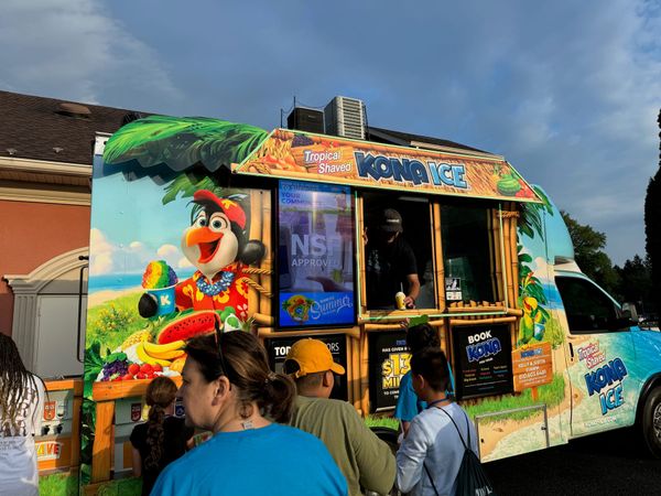 Kids lining up at an ice treat truck outside the church