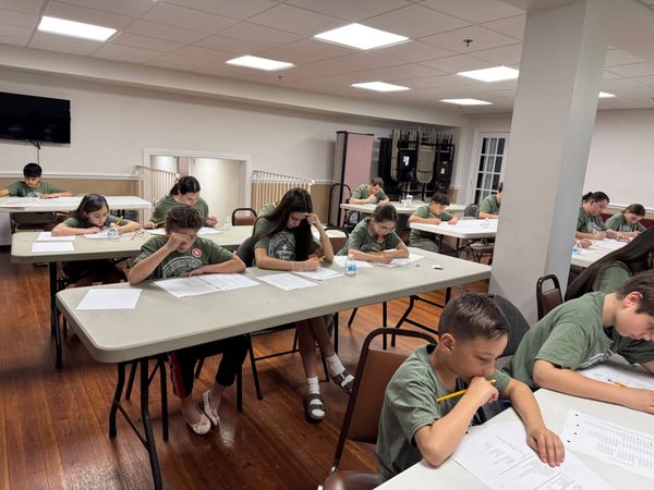 Children concentrating on their exam papers