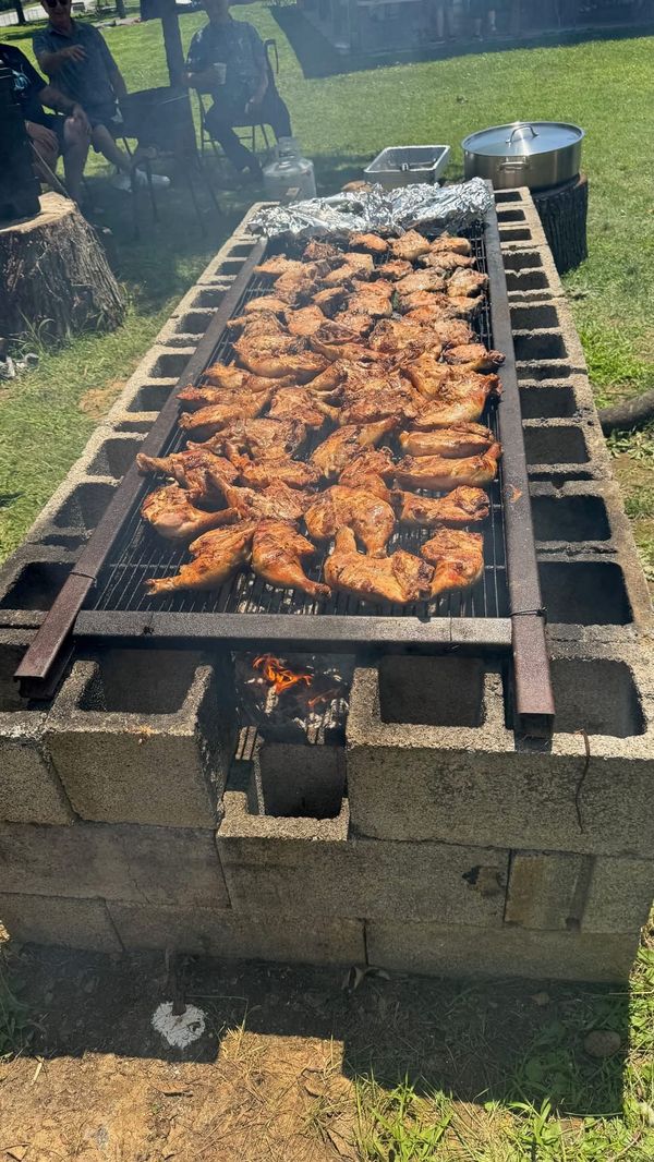 A long block grill covered with chicken